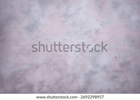 A soft, abstract background featuring a mottled texture with blended shades of light gray and pale pink, creating a gentle and artistic feel.