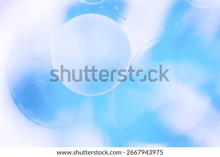 Soft abstract background with large translucent bubbles in blue and white tones, creating a light and airy texture