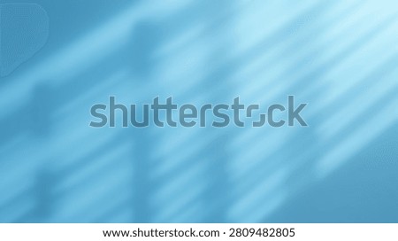A soft, abstract blue background featuring diagonal streaks of light and subtle shadow patterns, creating a serene and modern visual.