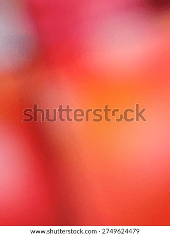 Soft abstract blur featuring a blend of red, pink, and orange light leaks.