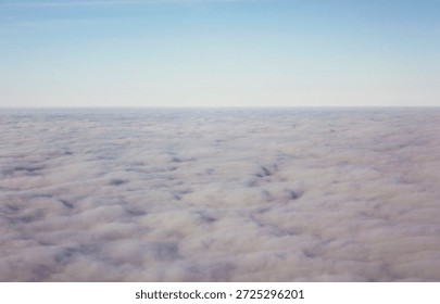 Soft abstract sky background with endless cloud layer under clear blue horizon, minimal atmospheric texture for calm design, meditation, travel concepts, serenity, freedom and peaceful mood