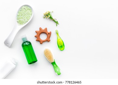 Soft Bath Cosmetics For Kids With Chamomile. Bottles, Spa Salt, Tooth Brush And Toy On White Background Top View Copyspace