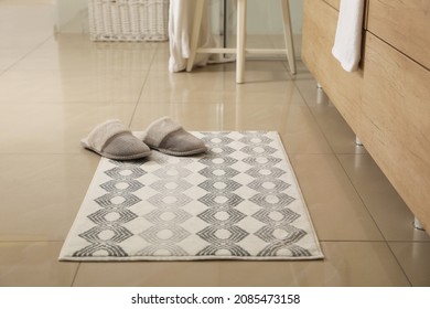 Soft Bath Mat And Slippers On Floor Indoors