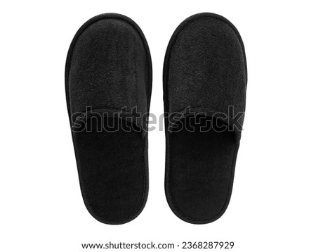Soft black home or spa slippers isolated on white background with clipping path. Blank, no label, mock up for your design logo. Flat lay , top view of black hotel slippers or sandals.