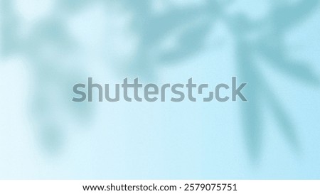 Soft blue background with a blurred leaf pattern. The blue background has a gentle, dreamy texture, creating a serene atmosphere. Blue textured desktop wallpaper with copy space.