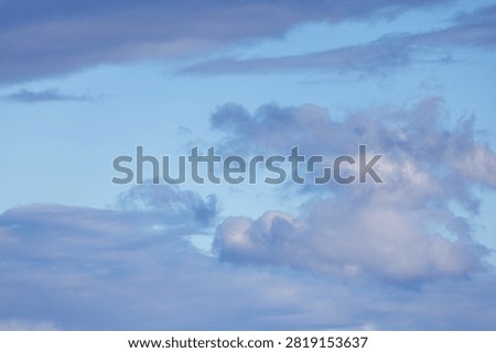 Soft blue cloudscape with layered twilight clouds and open sky, evoking calm, serene and airy feelings.