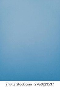 Soft blue solid color backdrop with subtle vignette, empty space for text or product display
