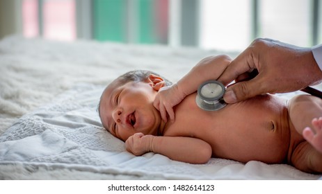 Soft blur of the doctor hands use stethoscope to check newborn baby health and take care him or cure the disease or disorder. Concept of help to support child patient health of family by physician. 