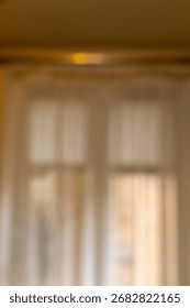 Soft, blurred background featuring sheer curtains gently diffusing sunlight in a cozy indoor setting, creating a tranquil atmosphere full of warmth and comfort.