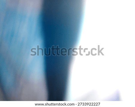 Soft, blurred composition featuring intense streaks of bright white light contrasting sharply against deep, cool blues and dark indigo tones, creating a minimal, ethereal, and abstract visual effect.