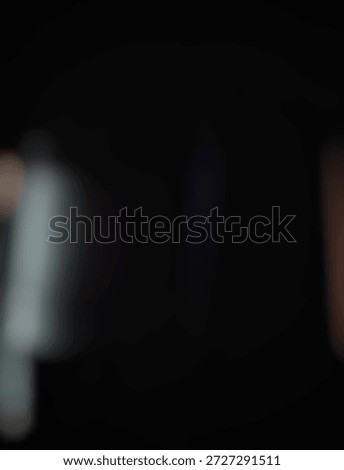 Soft blurred dark background with subtle bokeh and light leaks. Elegant abstract texture for overlays, wallpapers, or moody creative designs.