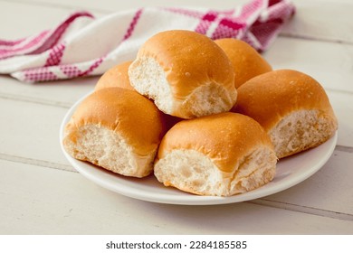Soft bread rolls on white plate