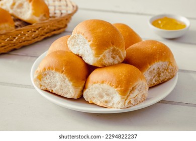 Soft bread rolls on white plate and jam