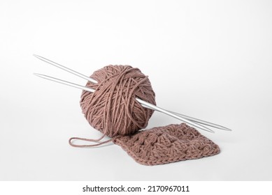 Soft Brown Woolen Yarn, Knitting And Metal Needles On White Background