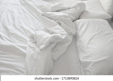 Soft And Calm Atmosphere Image Of All White Bed Room. Pillows And Blanket On Empty Bed, Close Up.