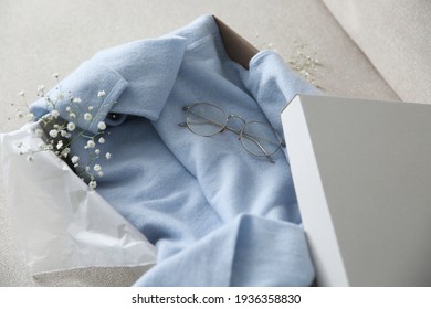 Soft Cashmere Sweater In Box On Sofa, Closeup