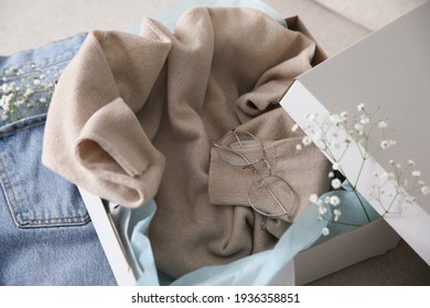 Soft Cashmere Sweater In Box On Sofa, Closeup