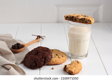 Soft And Chewy Chocolate Chip Cookies On White Table. Closeup Chocolate Chip Cookie Topping With Milk. Homemade Baked Chocolate Chip Soft Cookies.