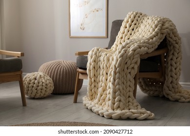 Soft Chunky Knit Blanket On Armchair In Room. Interior Design