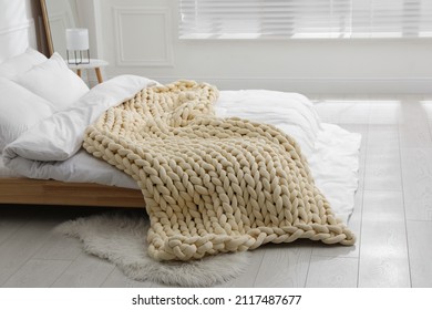 Soft Chunky Knit Blanket On Bed In Stylish Room Interior