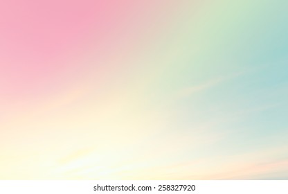 A soft cloud background and pastel colored orange to blue gradient 