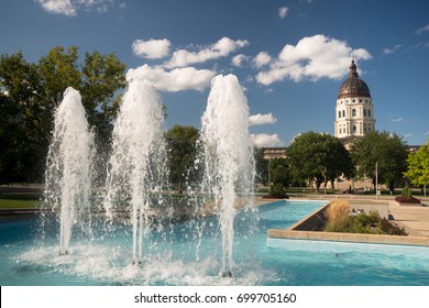 Soft clouds and blue skies appear over fountains and the capitol of Topeka, Kansas USA