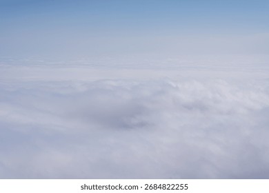 Soft cloudscape view from above with blue sky background