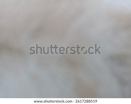 A soft, cloudy abstract background with a muted palette of light beige, ivory, and pale gray.