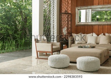 Soft and comfortable sofa with cushions in the lounge area with nice relaxing atmosphere. Cozy gorgeous comfortable resting area.