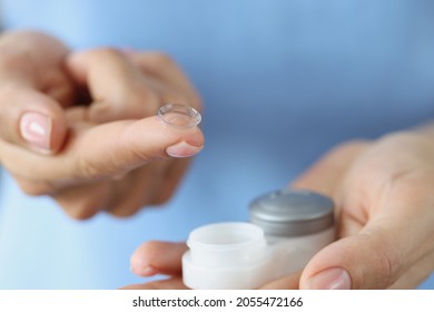 Soft Contact Lens On Finger And Storage Box Closeup