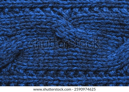 Soft dark blue wool cable ornament texture as background