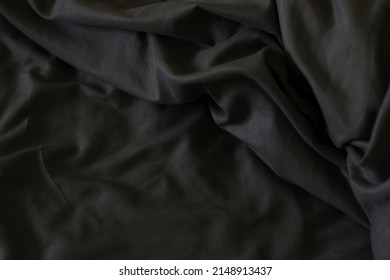 Soft Dark Cotton Bed Linen. Fluffy Grey Sheets on Bed. Silky Fabric Background. Perfect Morning. 