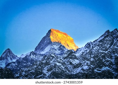Soft dawn light touching the summit - Dramatic Alpine Mountains at Dawn with Soft Morning Light - Dramatic winter mountain range with rugged peaks and soft golden sunlight at dawn, creating a serene and majestic natural scene.