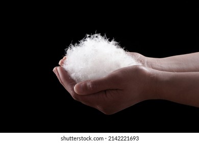 Soft Down Feather In Hand On Black Background