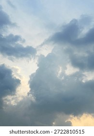 Soft Dramatic Cloudscape in Blue Sky with Sunlight Breaking Through Clouds