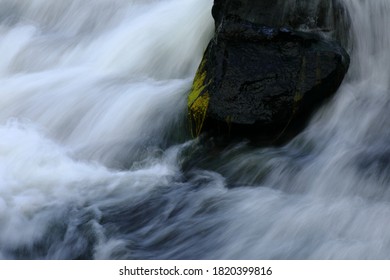 Soft, Dreamy, Water Rushing Around A Rock In The River.