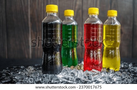 Soft drink bottles or Carbonated beverages on ice,a lot of bottles of Soft drinks in colorful Chilled on ice and flavorful on the ice cubes