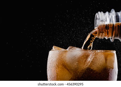 Soft drink : pour soda to a glass / focus at bottle