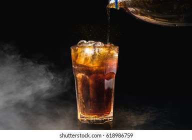 Soft Drink,Pouring A Coca Soda Into A Glass On Black Background