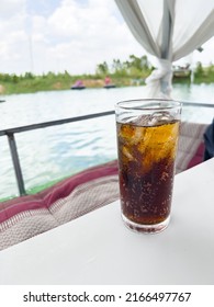 Soft drinks and ice in a tall glass  placed on a white table at the raft in the middle of the water  For relaxing on a hot day, Fizzy water, Thailand.