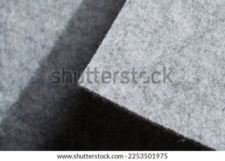 Soft felt textile material gray color, colorful texture flap fabric background closeup