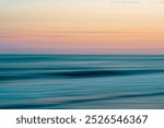 Soft, flowing waves blend seamlessly into the serene colors of the horizon.