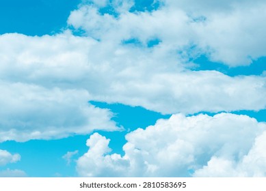 Soft, fluffy clouds float gracefully in a stunning blue sky, inviting daydreams and moments of reflection. Their gentle presence brightens the day and uplifts the spirit.