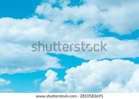 Soft, fluffy clouds float gracefully in a stunning blue sky, inviting daydreams and moments of reflection. Their gentle presence brightens the day and uplifts the spirit.