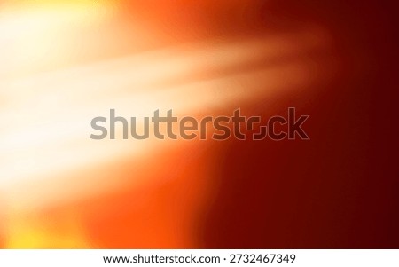 A soft focus abstract background features intense white and orange light emanating from the upper left corner, casting diagonal light rays across a deep reddish-brown field.