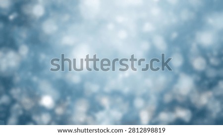 A soft focus abstract background with numerous blue and white bokeh lights, creating a dreamy and glittering effect.