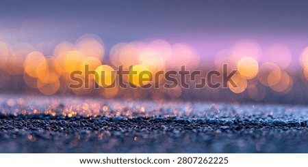 Soft focus abstract background with warm bokeh lights and a sparkling, glittering surface in the foreground, creating a magical atmosphere.