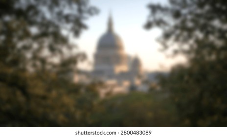 Soft focus abstract view of the iconic US Capitol dome in Washington DC framed by lush green foliage during golden hour