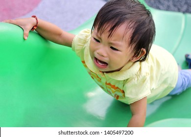 Soft Focus, Asian Baby Child Girl Crying And Sad Because She Falling From A Slider Bar Toy At The Playground.