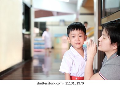 Soft Focus At Asian Little Boy Wearing School Uniform Crying And Mother Try To Encourage For Go To School.
The Mother Try To Comfort Her Kid. Concept Of Back To School,cheerful,family And Supporter.